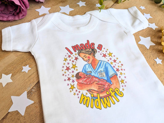White baby vest with long sleeves and colorful “I made a midwife” graphic