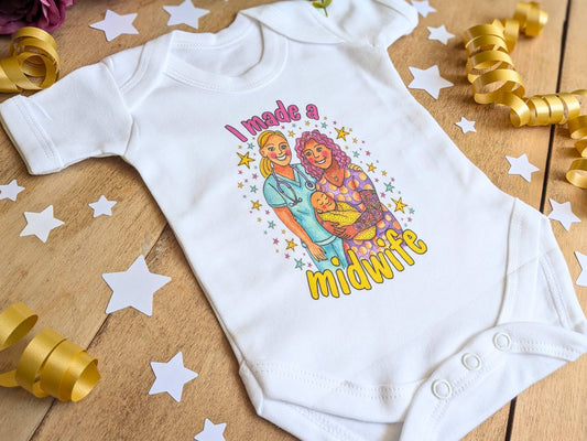 White baby vest bodysuit close-up with 'I made a midwife' illustrated graphic