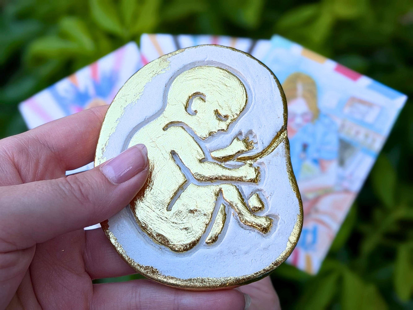 Golden baby in the womb fridge magnet