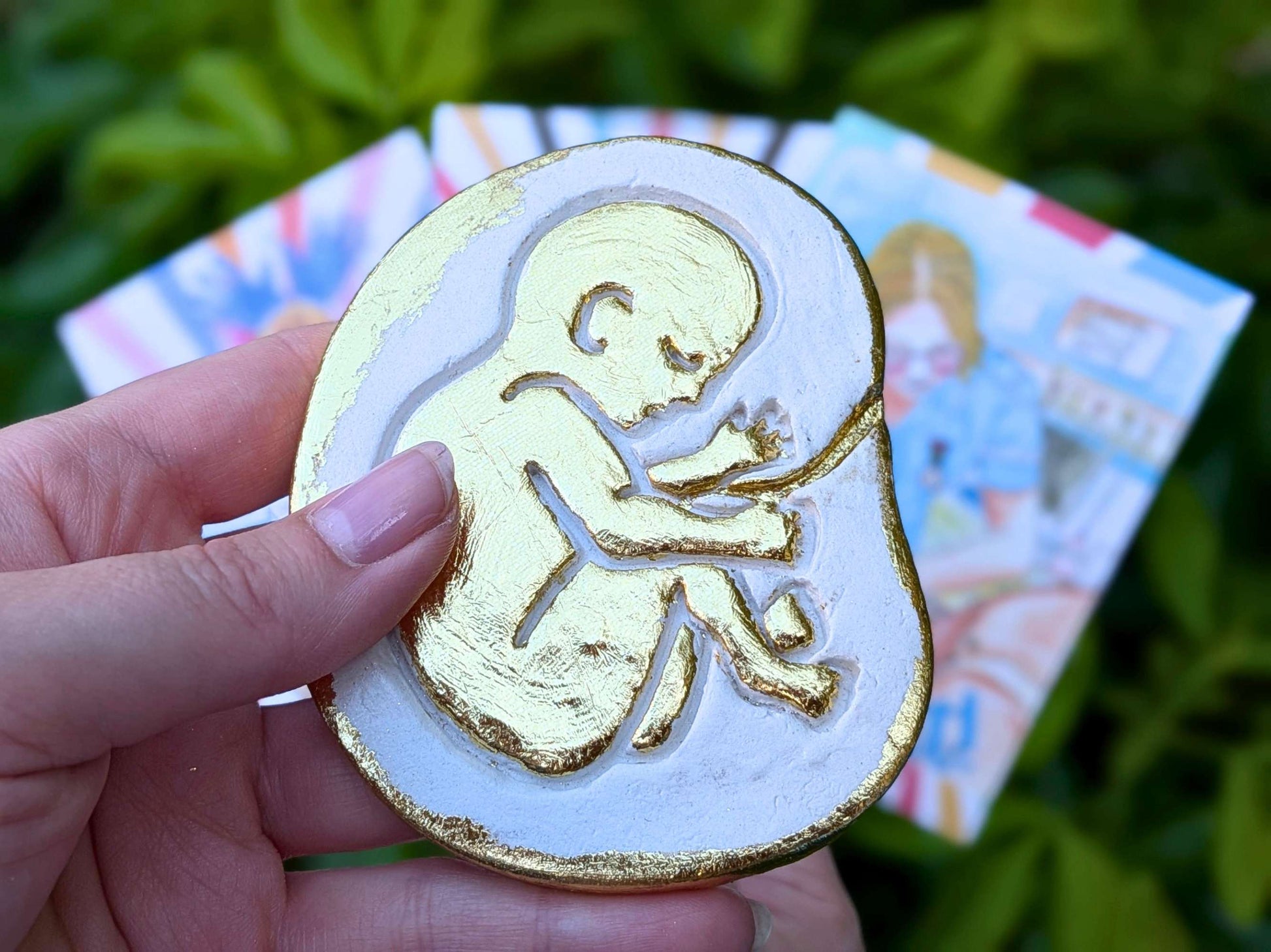 Golden baby in the womb fridge magnet