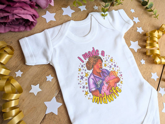 White short-sleeve baby vest with colorful 'I made a midwife' print