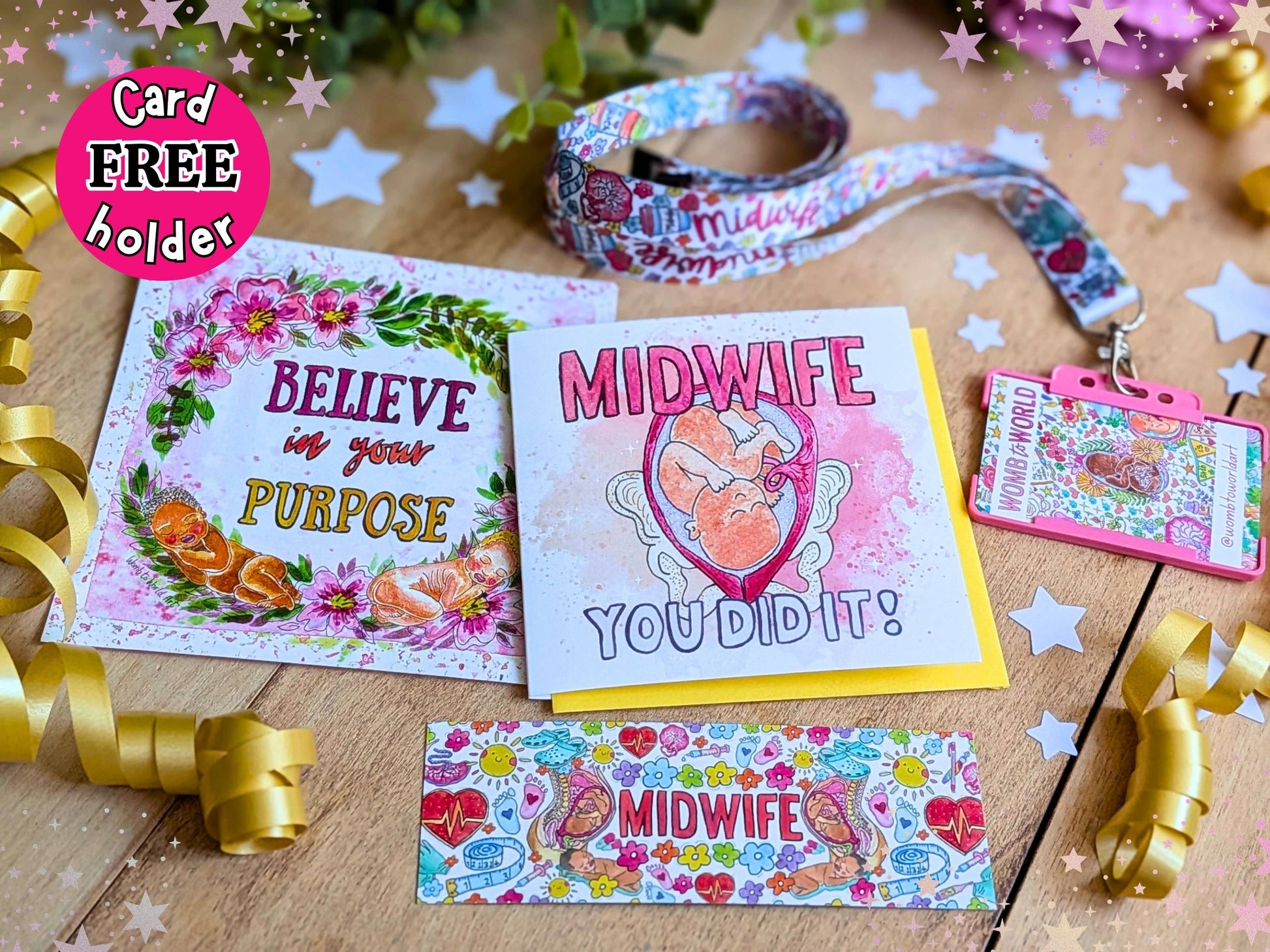 A coordinated midwife-themed stationery and ID accessory set arranged on a wooden surface with decorative stars, ribbons, and flowers. The set includes a floral greeting card reading 'BELIEVE in your PURPOSE,' a white card reading 'MIDWIFE YOU DID IT!' with a heart illustration, a matching patterned lanyard, a pink ID badge holder, and a small rectangular card or tag with colorful midwife motifs.